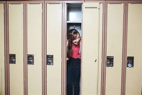 High School Student Laughing Inside Locker By Stocksy Contributor