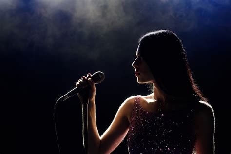 Premium Photo Portrait Of Beautiful Singing Woman On Dark Background