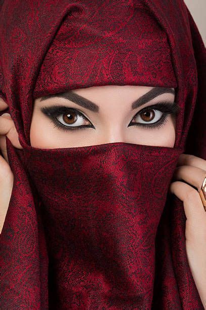 Portrait Of Beautiful Arabian Girl Hiding Her Face Behind Red Niqab