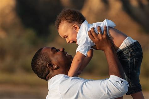Premium Photo Happy African American Father And Son Having Fun Outdoors