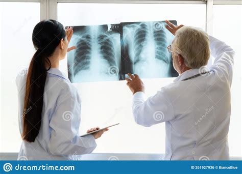 Two Doctors Examine Radiograph For Medical Xray Diagnosis In Sterile
