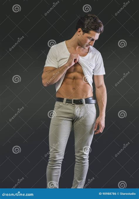 Handsome Young Man Pulling Up T Shirt Showing Abs Stock Photo Image