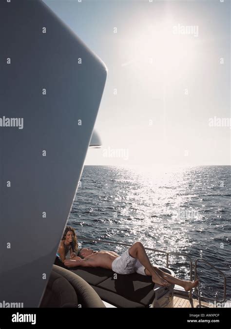Couple Sunbathing On Boat Stock Photo Alamy