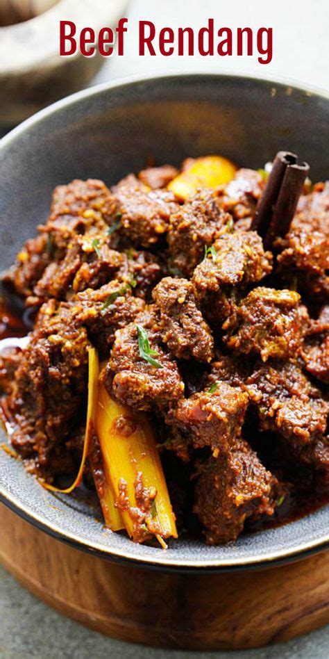 Beef Rendang In A Bowl With Spices On The Side And Text Overlay That