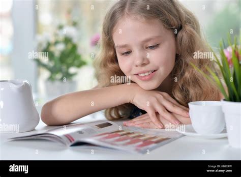 Little Girl Reading Magazine Stock Photo Alamy