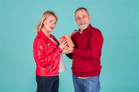 Free Photo Portrait Of Smiling Mature Man Giving Present To His Wife