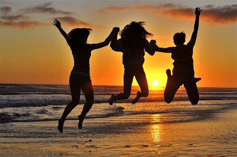 Three Girls Jumping At Sunset In Oceanside By Rich Cruse Photo