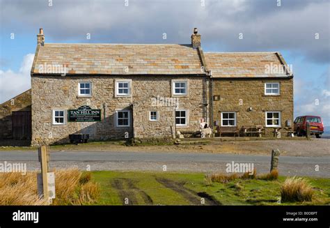 Female Sitting Outside Tan Hill Inn Swaledale North Yorkshire Uk At