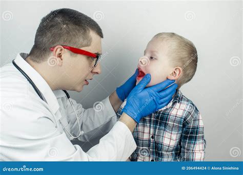 A Pediatrician Examines A Boy Who Complains Of A Sore Throat Diagnosis