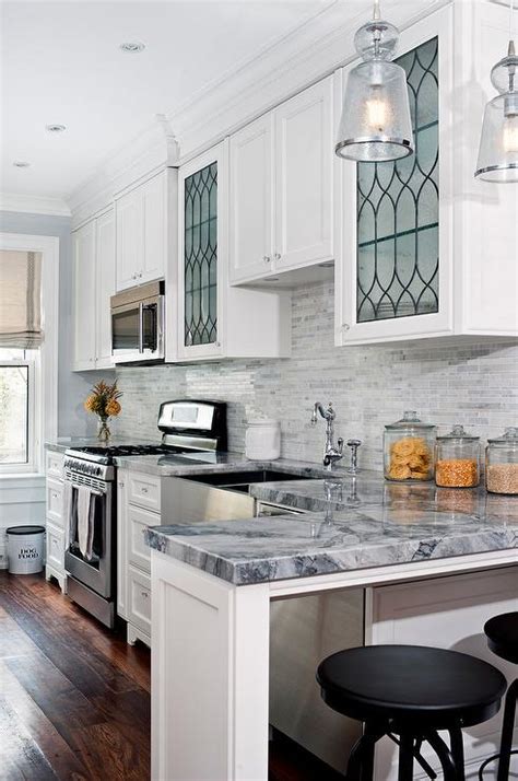 Glass cabinet inserts represent an ideal compromise between solid cabinetry and open shelving. Kitchen with Leaded Glass Cabinets - Transitional - Kitchen