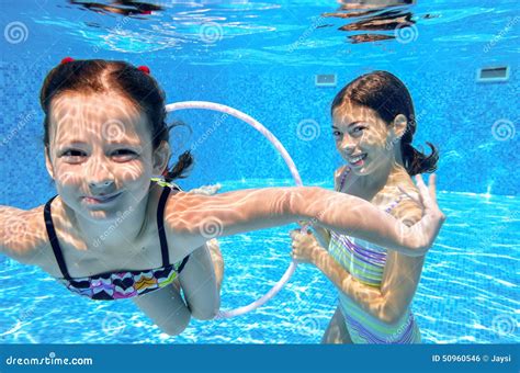 Happy Children Swim In Pool Underwater Girls Swimming Stock Photo