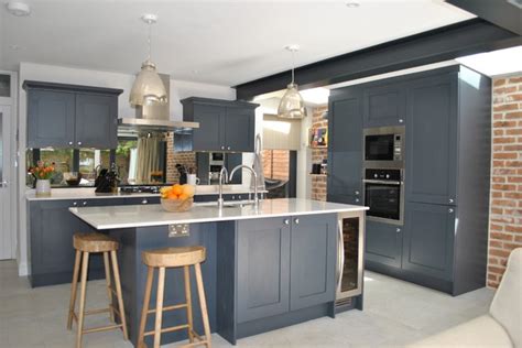 Modern Shaker Kitchen In Dark Slate Blue Against The Brick Wall