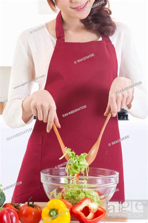 Young Woman Making Salad With Smile Stock Photo Picture And Royalty