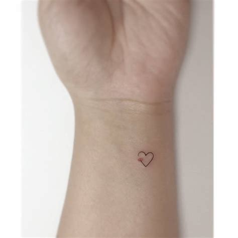Tiny Heart And Flower Tattoo Located On The Wrist
