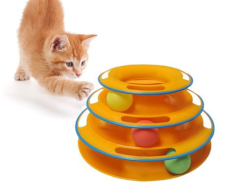 A Small Orange Kitten Playing With Three Plastic Bowls On The Floor And