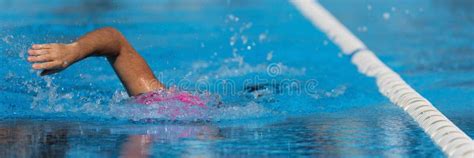 Swimmer Child Athlete Swimming In Pool Lanes Doing A Crawl Lap Stock
