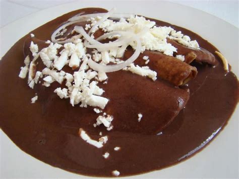 Enfrijoladas Corn Tortillas Filled With Panela Cheese Garnished With