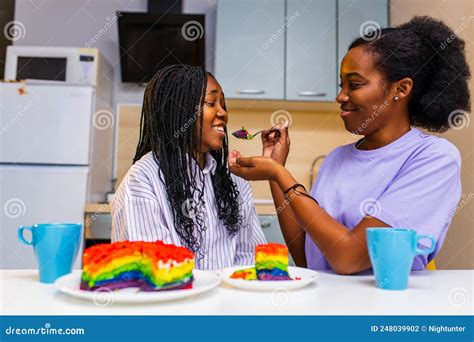 Multiethnic Lovely Same Sex Lovers Feeding Each Other By Rainbow Cake