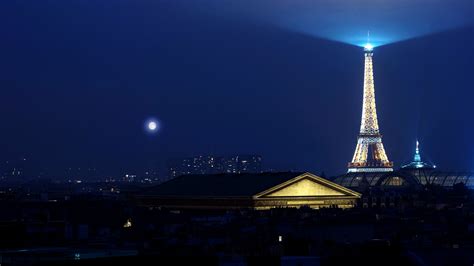 Paris Eiffel Tower On Side With Lighting On Top With Background Of Blue