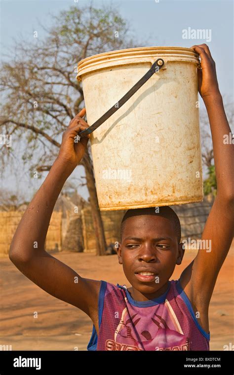 Young Preteen Girl Carries Water Water Accompanied By Her Sister In