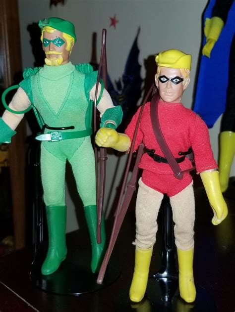 Two Action Figures Are Posed On A Table