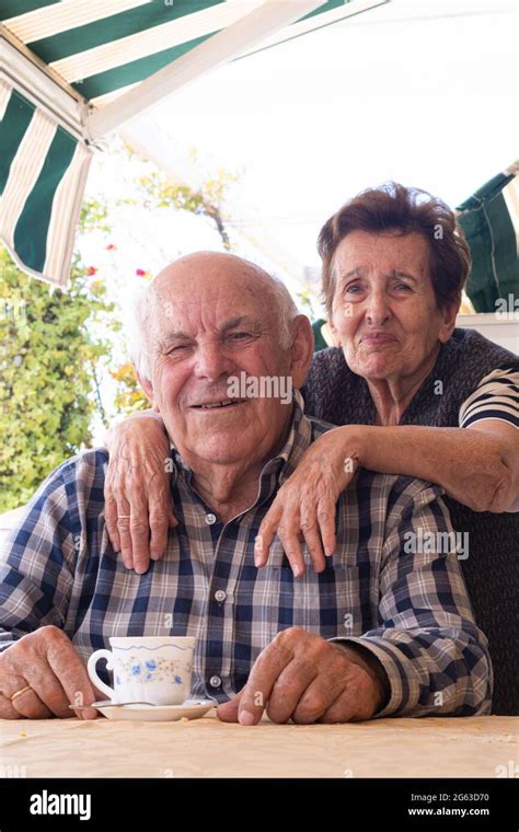 Aged Woman Hugs Her Husband From Behind Stock Photo Alamy