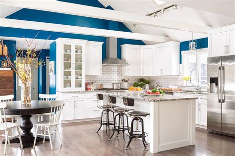 White And Blue Kitchen With Wood Beams On Vaulted Ceiling