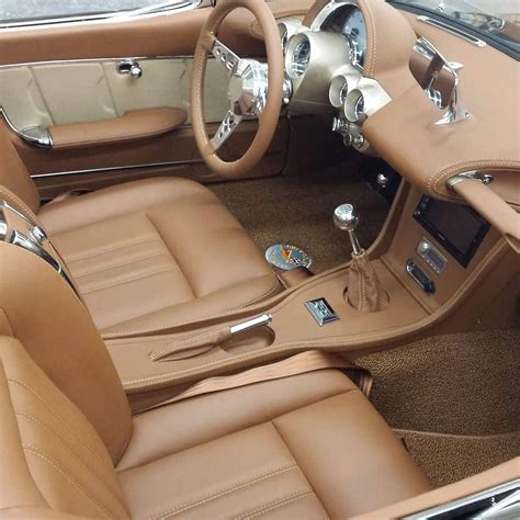 The Interior Of A Classic Car With Tan Leather