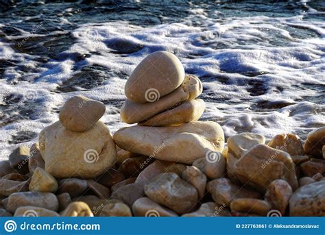 Stacked Pebbles In Front Of Foamy Sea Surface Stock Image Image Of