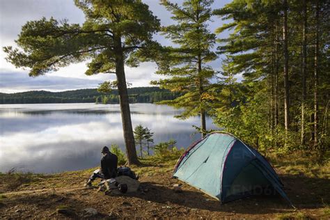 Hiker Camping By Provoking Lake In Algonquin Provincial Park Ontario