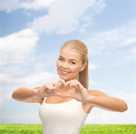 Premium Photo Love And Gesture Concept Smiling Woman Showing Heart