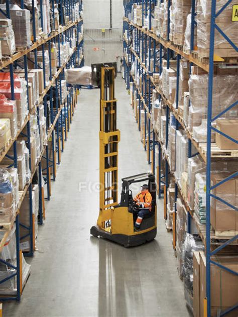 Worker Operating Forklift In Warehouse — Full Length Safety Stock