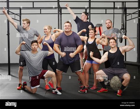 Portrait Of Eight People Flexing Muscles In Gym Stock Photo Alamy