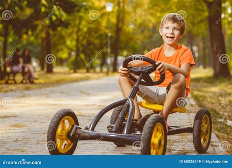 Happy Smiling Boy Driving A Toy Car Outdoor In The Stock Image Image