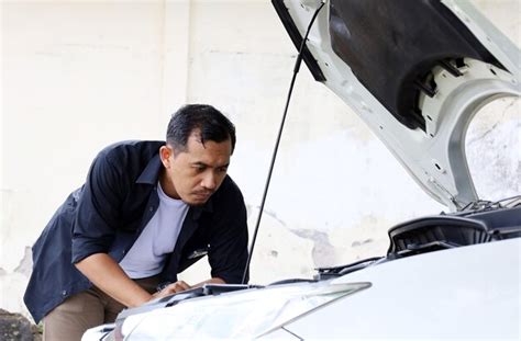 Premium Photo Asian Man Is Trying To Fix Broken Down Car