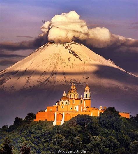 An Image Of A Mountain With Clouds In The Sky