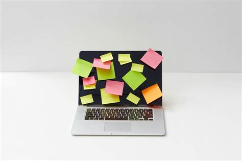 Close Up Shot Of A Laptop With Sticky Notes On A White Surface · Free