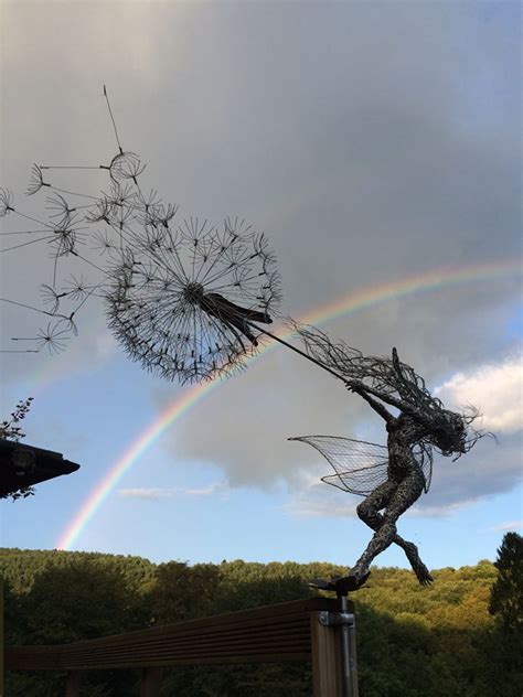 Wind Blown Fairy Clutching Dandelions With Rainbow From East Sculptor