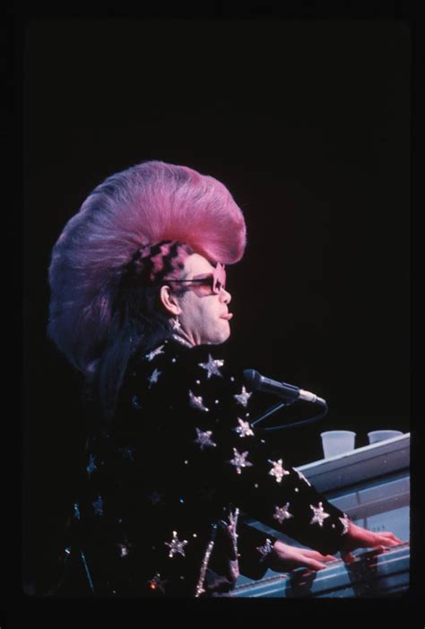 Elton John Wearing Mackie Costume Featuring A Pink Mohawk Bygonely