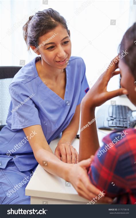 Female Doctor Treating Patient Suffering Depression Stock Photo