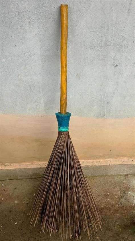 A Broom Stick Leaning Against The Outside Wall Of The House 17661140