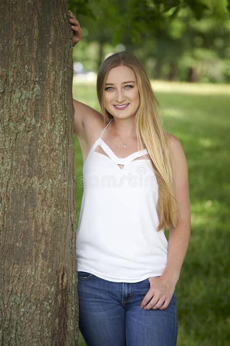 Stunning Young Blonde Woman Posed For Photo In Woods Orange Tank Top