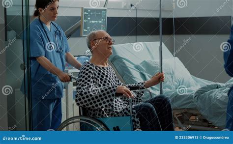 Senior Patient Leaving Hospital Ward In Wheelchair Stock Image Image