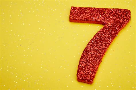 Number Seven Red Color Over A Yellow Background Anniversary Stock Photo