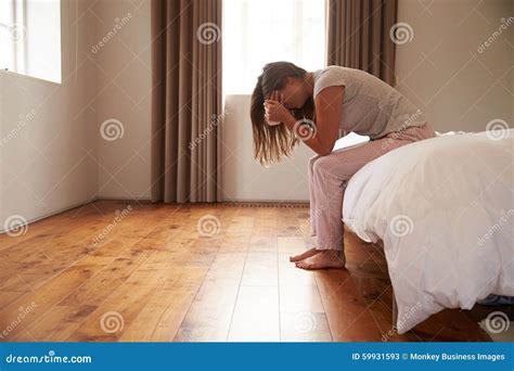 Woman Suffering From Depression Sitting On Bed And Crying Stock Image