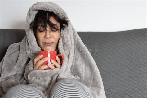 Mature Woman Of Middle Eastern Ethnicity Drinking A Cup Of Hot Coffee