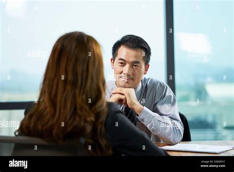 Asian Hr Manager Interviewing A Female Job Candidate In Office Stock