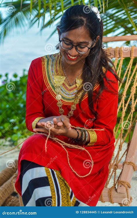 Beautiful Maldivian Girl In National Dress Crafting Hand Made Rope