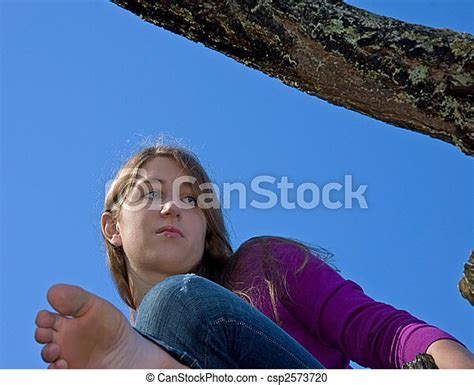 Teen Barefoot In Tree This Teen Has A Serious Facial Expression As She