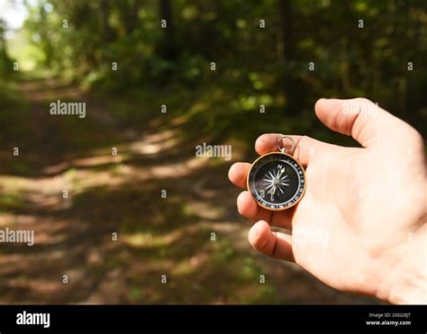 Compass In Hand At Forest Tourist Compass For Orientation On The